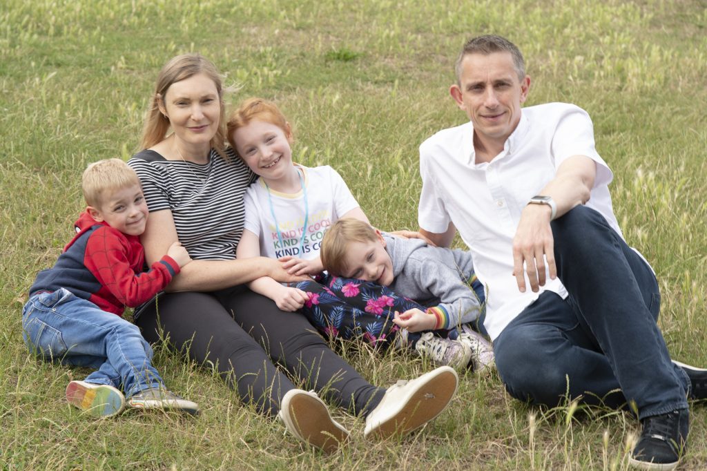 Adèle, 46, with her husband Stuart, 48, and Charlotte, 8, Dylan, 5 and Tyler, 5