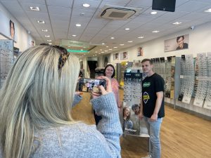 Our colleague taking photos of customers in Specsavers store.